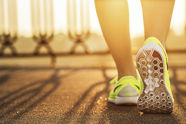 Woman running a long a road at sunrise. Thailand-Property.com