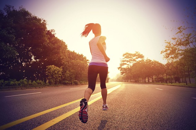 WOman running on a road at sunrise before the heat picks up. Thailand-Property.com