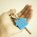 Hand holding a key to a new home.