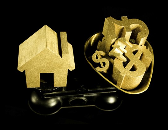 house prices, first time buyer, gold house and money symbols on scales. Thailand-Property.com