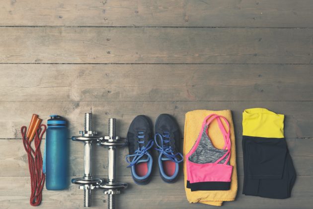 top view of fitness, gym equipment on wooden floor